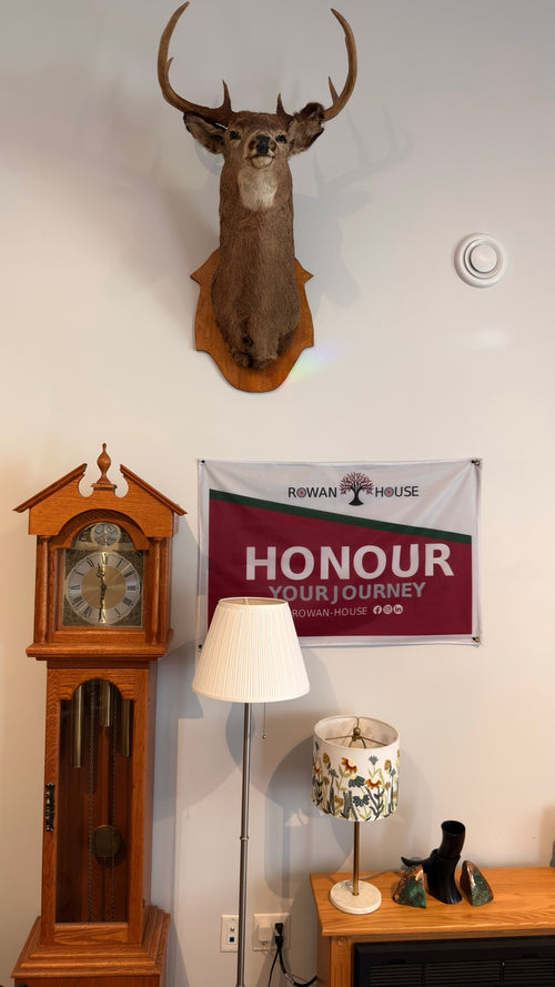 Rowan House interior — clock and Honour Your Journey banner