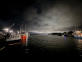 Fishing boats in a quiet Nova Scotia harbour beneath an evening sky, reflecting a moment of pause and reset.