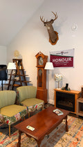 Rowan House interior — lounge with chairs, clock and fireplace